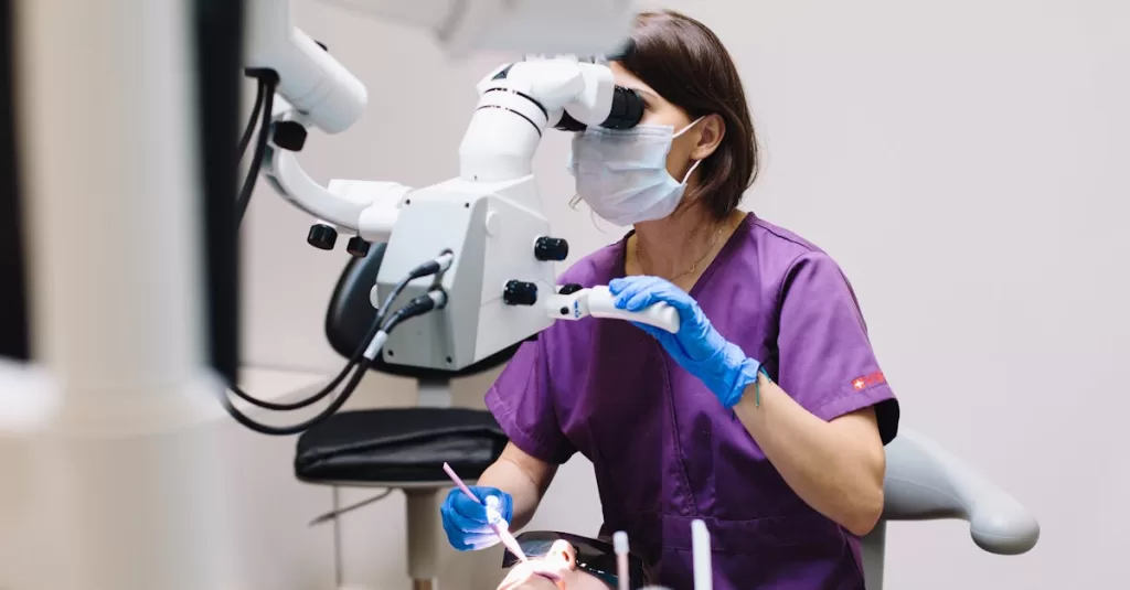 Female dentist using a microscope and modern technology during a patient examination in a dental clinic.