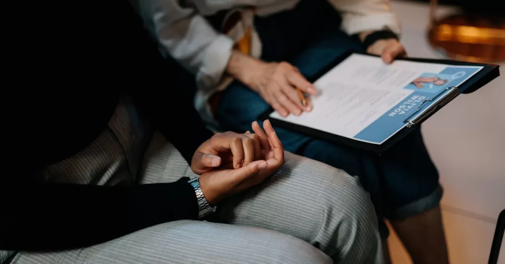 Two professionals reviewing a resume in an office setting, focused on teamwork.