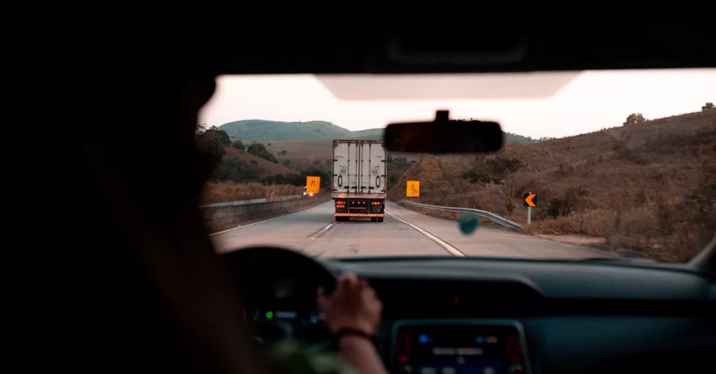 Scenic drive with a truck on a highway surrounded by hills. Perfect for travel themes.